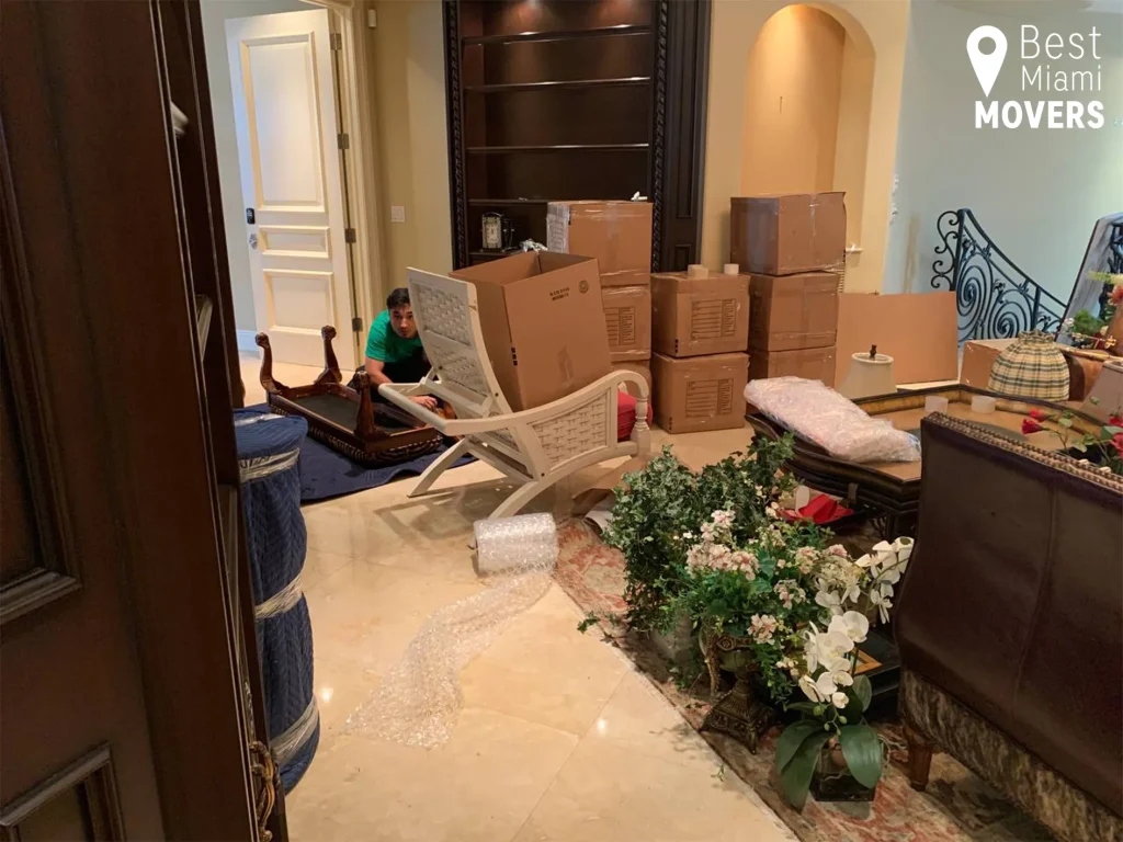 Best Miami Movers Storage Services Team Member Packing Boxes and Furniture