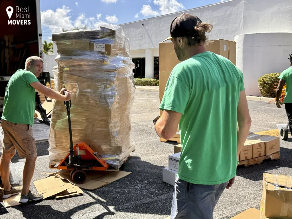 Local Moving Team Members Unloading Customer Boxes from Comercial Truck