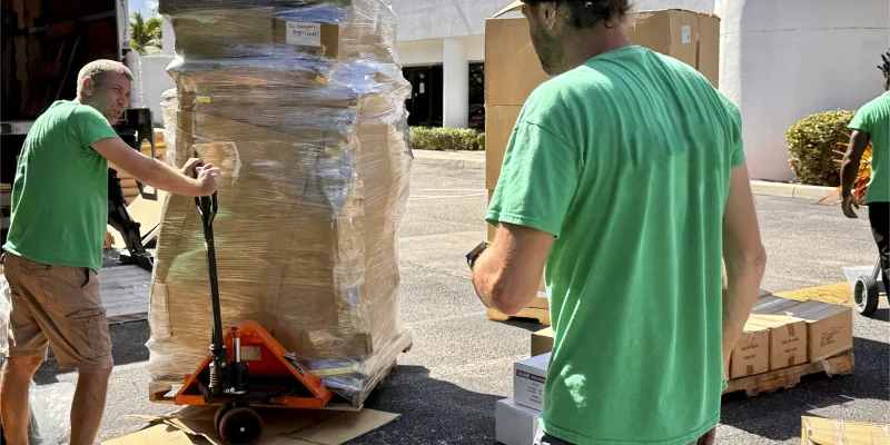 Local Moving Team Members Unloading Customer Boxes from Comercial Truck